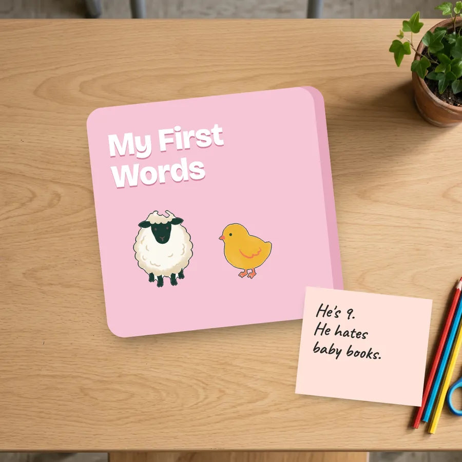 A pink toddler board book next to a note that says he is nine